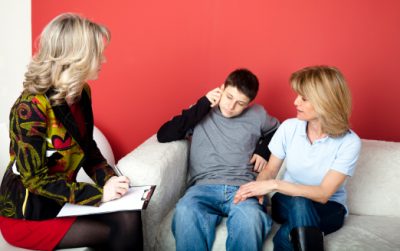 Child and parent in therapy session psychologist