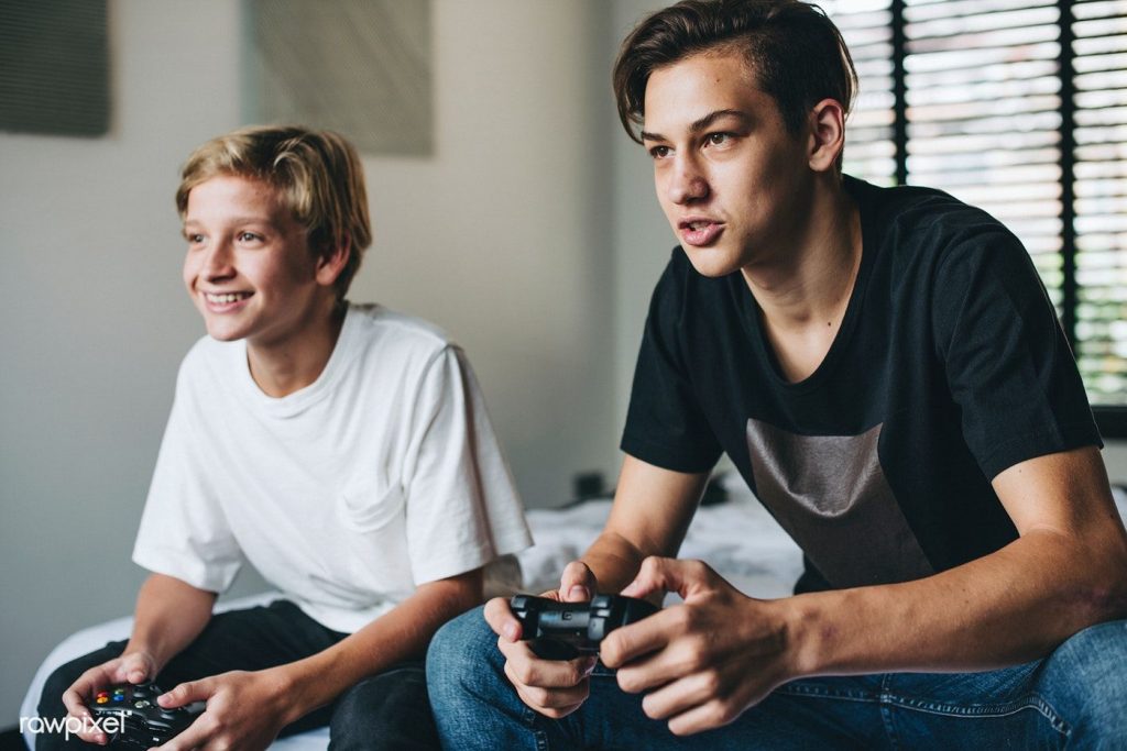 Teenage boys playing video gaming games 1